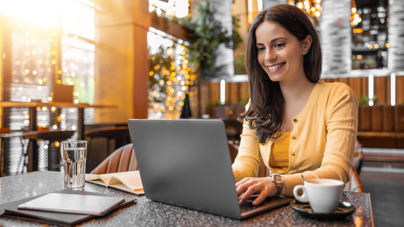 Female working on laptop in modern cafe